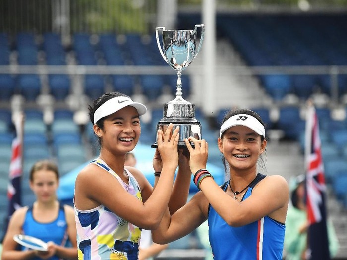 MELBOURNE, AUSTRALIA - JANUARY 31: Alexandra Eala of the Philippines and Priska Madelyn Nugroho of Indonesia pose with the championship trophy after winning their Junior Girls DoublesÂ Final against Ziva Falkner of Slovenia and Matilda Mutavdzic of Great Britain on day twelve of the 2020 Australian Open at Melbourne Park on January 31, 2020 in Melbourne, Australia. (Photo by Morgan Hancock/Getty Images)