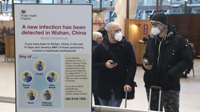 Passengers arrive at Heathrow Airport in London after the last British Airways flight from China touched down in the UK following an announcement that the airline was suspending all flights to and from mainland China with immediate effect amid the escalating coronavirus crisis, Wednesday Jan. 29, 2020. Many governments have warned against unnecessary travel to China, as efforts to contain a new and deadly coronavirus virus intensify. (Steve Parsons/PA via AP)