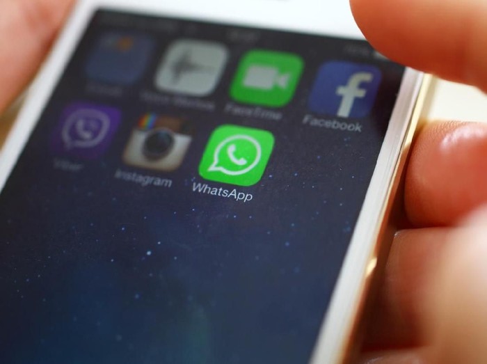WhatsApp Wien,Austria-February 25,2014: Closeup of female hand holding an iPhone 5s while launching WhatsApp,a popular messaging application .