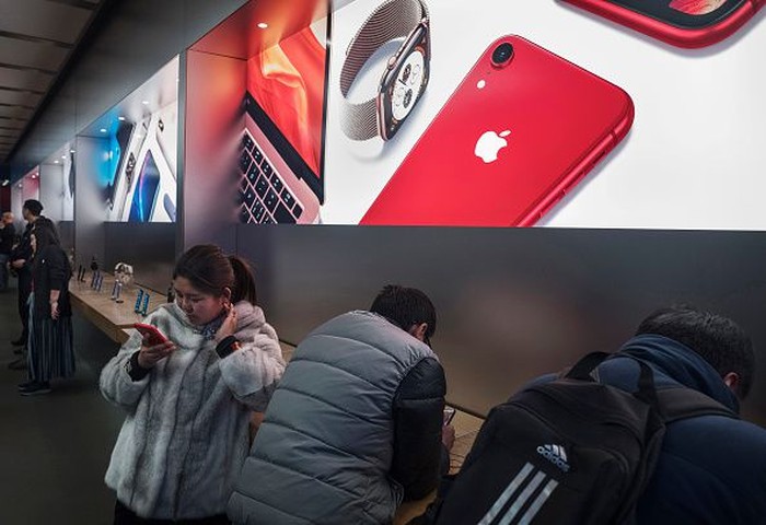 BEIJING, CHINA - FEBRUARY 01: A Chinese employee wears a protective mask as he sits in the showroom of an Apple Store after it closed for the day on February 1, 2020 in a shopping district in Beijing, China. Apple announced it was closing all of its stores in China until February 9th due to the outbreak of the coronavirus in Wuhan, The number of cases of a deadly new coronavirus rose to almost 12000 in mainland China Saturday, days after the World Health Organization (WHO) declared the outbreak a global public health emergency. China continued to lock down the city of Wuhan in an effort to contain the spread of the pneumonia-like disease which medicals experts have confirmed can be passed from human to human. In an unprecedented move, Chinese authorities have put travel restrictions on the city which is the epicentre of the virus and neighbouring municipalities affecting tens of millions of people. The number of those who have died from the virus in China climbed to over 250 on Saturday, mostly in Hubei province, and cases have been reported in other countries including the United States, Canada, Australia, Japan, South Korea, India, the United Kingdom, Germany, France and several others. The World Health Organization  has warned all governments to be on alert and screening has been stepped up at airports around the world. (Photo by Kevin Frayer/Getty Images)