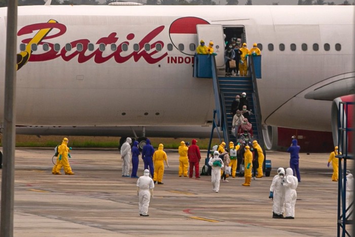 Sebanyak 250 WNI yang dievakuasi dari Kota Wuhan, China turun dari pesawat setibanya di Bandara Hang Nadim, Batam, Kepulauan Riau, Minggu (2/2/2020). WNI yang dievakuasi dari Wuhan tersebut kemudian diterbangkan kembali menuju Ranai, Natuna untuk menjalani observasi. ANTARA FOTO/M N Kanwa/aww.