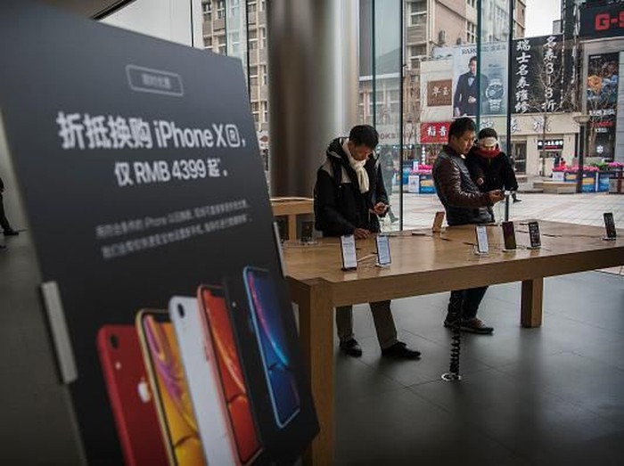 BEIJING, CHINA - JANUARY 07:  Customers look at iPhones on display at an Apple Store on January 7, 2019 in Beijing, China. Apple Inc. lowered its revenue guidance last week, blaming Chinas slowing economy and weaker than expected iPhone sales, as the companys chief executive officer Tim Cook said in a letter to investors the sales problems were primarily in its Greater China region that accounts for almost 20 percent of its revenue and includes Hong Kong and Taiwan. (Photo by Kevin Frayer/Getty Images)