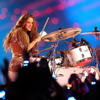 Dari merah, Shakira lalu tampil dengan busana serba emas saat unjuk kebolehan bermain drum dan berduet dengan Jennifer Lopez. Emas untuk memanjakan mata, tambah Bru. (Foto: Getty Images)