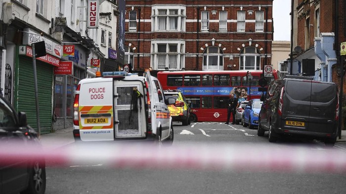 Police attend the scene after an incident in Streatham, London, Sunday Feb. 2, 2020. London police say officers shot a man during a â€œterrorism-related incidentâ€ that involved the stabbings of â€œa number of people.â€ (Victoria Jones/PA via AP)