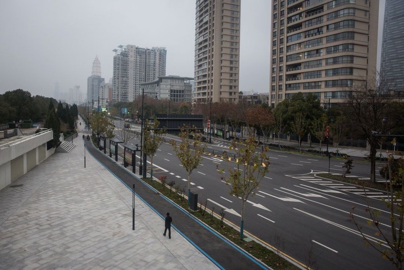 WUHAN, CHINA - JANUARY 31:  (CHINA OUT) A man wears a protective mask as he ride a bicycle across the Yangtze River Bridge on January 31, 2020 in Wuhan, China.  World Health Organization (WHO) Director-General Tedros Adhanom Ghebreyesus said on January 30 that the novel coronavirus outbreak has become a Public Health Emergency of International Concern (PHEIC).  (Photo by Stringer/Getty Images)