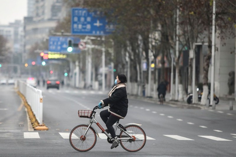WUHAN, CHINA - JANUARY 31:  (CHINA OUT) A man wears a protective mask as he ride a bicycle across the Yangtze River Bridge on January 31, 2020 in Wuhan, China.  World Health Organization (WHO) Director-General Tedros Adhanom Ghebreyesus said on January 30 that the novel coronavirus outbreak has become a Public Health Emergency of International Concern (PHEIC).  (Photo by Stringer/Getty Images)