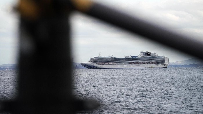 Cruise ship Diamond Princess anchored off the Yokohama Port, Japan, upon its arrival on Monday Feb. 3, 2020. A person who was a passenger on the Japanese-operated cruise ship has tested positive for a new virus after leaving the ship in Hong Kong on Jan. 25. A team of quarantine officials and medical staff boarded the ship on Monday night and began medical checks of everyone on board, a health ministry official said on condition of anonymity, citing department rules.(Kyodo News via AP)
