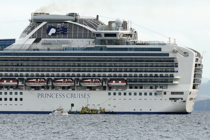 Cruise ship Diamond Princess anchored off the Yokohama Port, Japan, upon its arrival on Monday Feb. 3, 2020. A person who was a passenger on the Japanese-operated cruise ship has tested positive for a new virus after leaving the ship in Hong Kong on Jan. 25. A team of quarantine officials and medical staff boarded the ship on Monday night and began medical checks of everyone on board, a health ministry official said on condition of anonymity, citing department rules.(Kyodo News via AP)