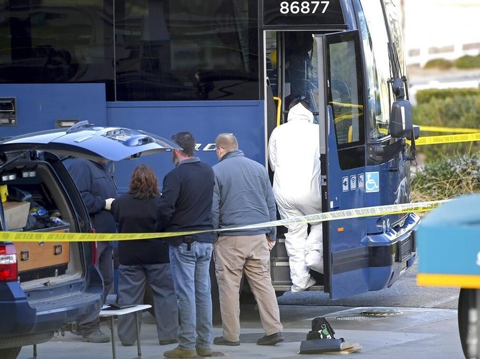 Investigators are seen outside of a Greyhound bus after a passenger was killed on board on Monday, Feb. 3, 2020 in Lebec, Calif. A gunman killed one passenger and wounded five others on a Greyhound bus traveling from Los Angeles to the San Francisco Bay Area early Monday morning, the California Highway Patrol said. (AP Photo/Jayne Kamin-Oncea)