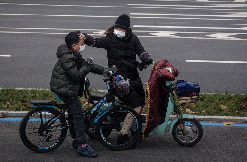 WUHAN, CHINA - JANUARY 31:  (CHINA OUT) A man wears a protective mask as he ride a bicycle across the Yangtze River Bridge on January 31, 2020 in Wuhan, China.  World Health Organization (WHO) Director-General Tedros Adhanom Ghebreyesus said on January 30 that the novel coronavirus outbreak has become a Public Health Emergency of International Concern (PHEIC).  (Photo by Stringer/Getty Images)
