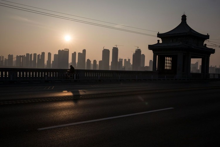 WUHAN, CHINA - JANUARY 31:  (CHINA OUT) A man wears a protective mask as he ride a bicycle across the Yangtze River Bridge on January 31, 2020 in Wuhan, China.  World Health Organization (WHO) Director-General Tedros Adhanom Ghebreyesus said on January 30 that the novel coronavirus outbreak has become a Public Health Emergency of International Concern (PHEIC).  (Photo by Stringer/Getty Images)