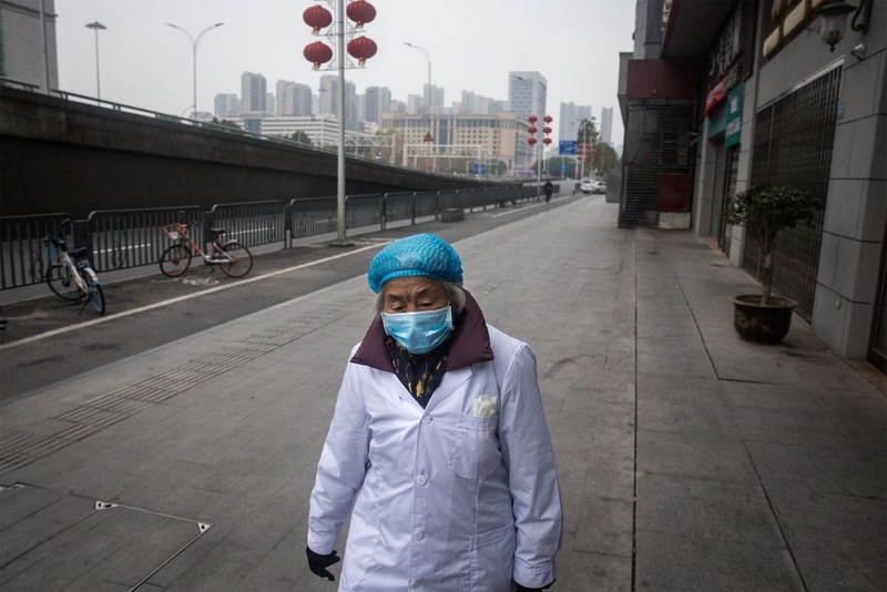 WUHAN, CHINA - JANUARY 31:  (CHINA OUT) A man wears a protective mask as he ride a bicycle across the Yangtze River Bridge on January 31, 2020 in Wuhan, China.  World Health Organization (WHO) Director-General Tedros Adhanom Ghebreyesus said on January 30 that the novel coronavirus outbreak has become a Public Health Emergency of International Concern (PHEIC).  (Photo by Stringer/Getty Images)