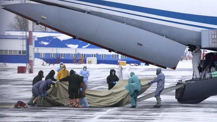 A group of medical personnel prepare to meet 80 people, accompanied by medical specialists, carried by a Russian military plane at an airport outside Tyumen, Russia, Wednesday, Feb. 5, 2020. Russia has evacuated 144 people, Russians and nationals of Belarus, Ukraine and Armenia, from the epicenter of the coronavirus outbreak in Wuhan, China, on Wednesday. All evacuees will be quarantined for two weeks in a sanatorium in the Tyumen region in western Siberia, government officials said. (AP Photo/Maxim Slutsky)