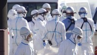Petugas membawa barang-barang milik penumpang yang terkena corona. Koki Sengoku/Kyodo News via AP.