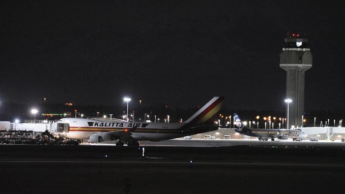 Carrying some 240 American diplomats and citizens, a Boeing 747 aircraft sits on the tarmac of Ted Stevens Anchorage International Airport in Anchorage, Alaska Tuesday, Jan. 28, 2020. Chartered by the U.S. government, the plane flew from Wuhan, China, the source of the recent coronavirus outbreak. The plane will refuel while passengers clear customs and go through the Centers for Disease Control screening before heading to Ontario, California. (AP Photo/Michael Dinneen)