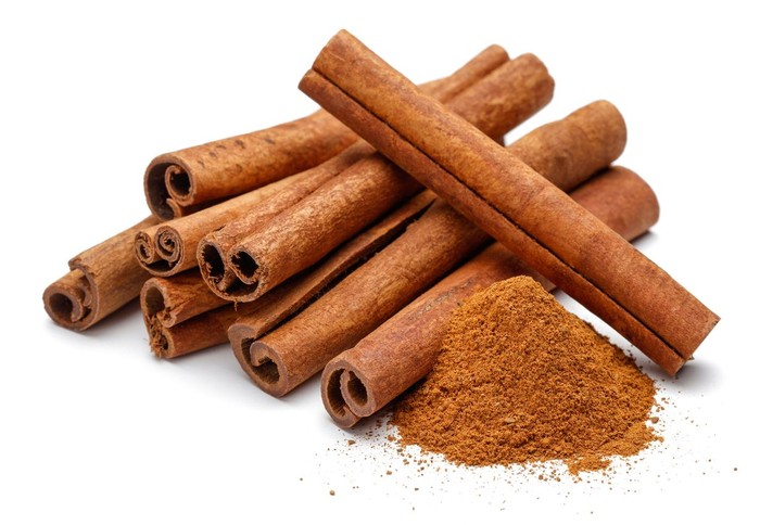 Cinnamon sticks and powder isolated on white background