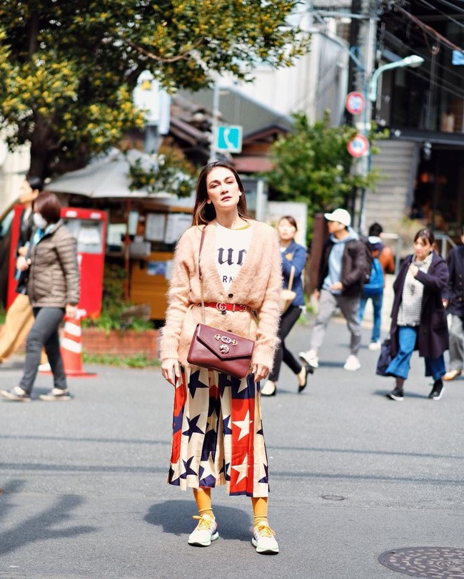 Ingin tampil lebih berwarna? Street style Luna Maya yang satu ini bisa jadi inspirasi. Celana kulot bermotif bintang dipadukannya dengan cardigan pink dan kaus kaki mustard. Foto: Instagram @ lunamaya