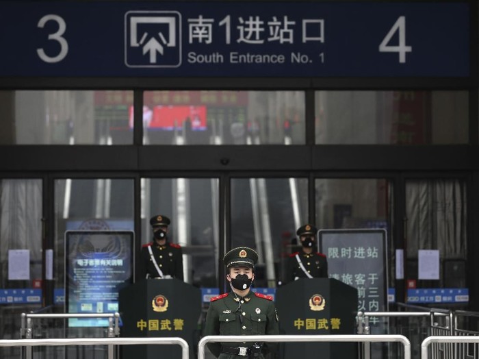 FILE - In this Jan. 23, 2020, file photo, Chinese paramilitary police stand guard outside the closed Hankou Railway Station in Wuhan in central Chinas Hubei Province. Cutting off access to entire cities with millions of residents to stop a new virus outbreak is a step few countries other than China would consider, but it is made possible by the ruling Communist Partys extensive social controls and experience fighting the 2002-03 outbreak of SARS. (Chinatopix via AP, File)