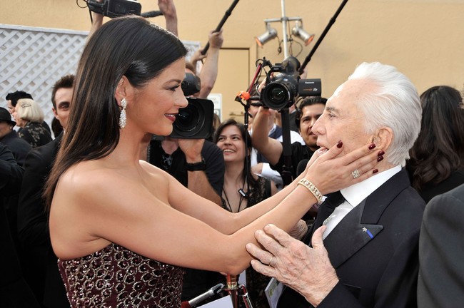 Catherine Zeta-Jones menyapa ayah mertuanya ketika bertemu di  AFI Life Achievement Award 2009. Ajang tersebut digelar untuk mengapresiasi karier Michael Douglas sebagai aktor Hollywood. (Foto: Kevin Winter/Getty Images for AFI)
