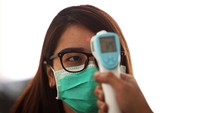 Satu persatu warga yang hadir diperiksa dengan menggunakan alat pengukur suhu.