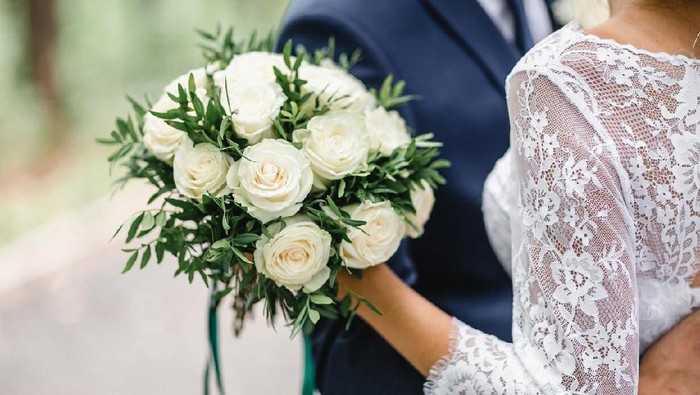 Happy bride and groom on their wedding hugging