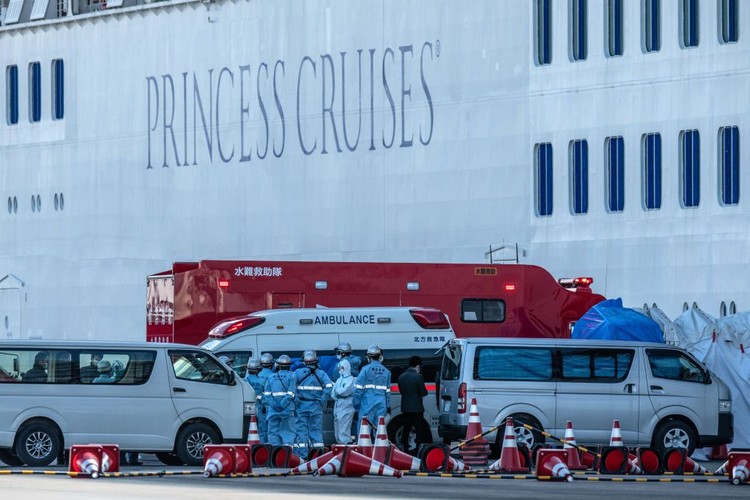 YOKOHAMA, JAPAN - FEBRUARY 06: An ambulance carries a coronavirus victim from the Diamond Princess cruise ship while it is docked at Daikoku Pier where it will be resupplied and newly diagnosed coronavirus cases taken to hospital as it remains in quarantine off the port of Yokohama after a number of the 3,700 people on board were confirmed to have coronavirus, on February 6, 2020 in Yokohama, Japan. 20 passengers are confirmed to be infected with coronavirus as Japanese authorities continue screening people on board. The new cases bring the total number of confirmed infections to 45 in Japan, the largest number outside of China. (Photo by Carl Court/Getty Images)