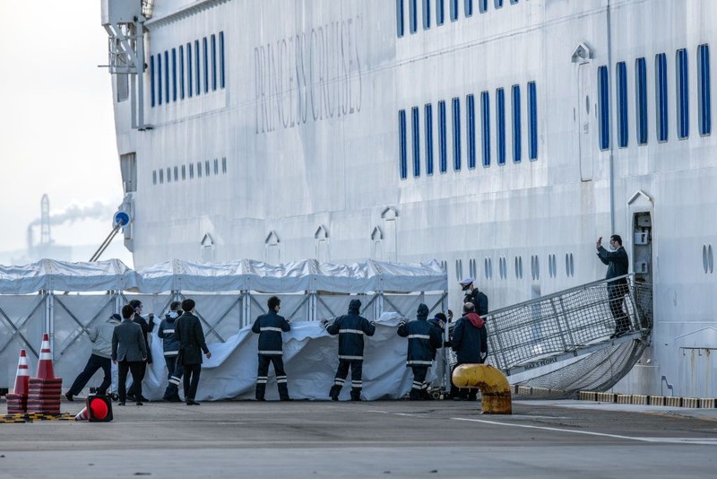 YOKOHAMA, JAPAN - FEBRUARY 06: An ambulance carries a coronavirus victim from the Diamond Princess cruise ship while it is docked at Daikoku Pier where it will be resupplied and newly diagnosed coronavirus cases taken to hospital as it remains in quarantine off the port of Yokohama after a number of the 3,700 people on board were confirmed to have coronavirus, on February 6, 2020 in Yokohama, Japan. 20 passengers are confirmed to be infected with coronavirus as Japanese authorities continue screening people on board. The new cases bring the total number of confirmed infections to 45 in Japan, the largest number outside of China. (Photo by Carl Court/Getty Images)