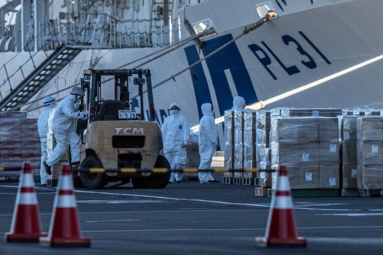 YOKOHAMA, JAPAN - FEBRUARY 06: An ambulance carries a coronavirus victim from the Diamond Princess cruise ship while it is docked at Daikoku Pier where it will be resupplied and newly diagnosed coronavirus cases taken to hospital as it remains in quarantine off the port of Yokohama after a number of the 3,700 people on board were confirmed to have coronavirus, on February 6, 2020 in Yokohama, Japan. 20 passengers are confirmed to be infected with coronavirus as Japanese authorities continue screening people on board. The new cases bring the total number of confirmed infections to 45 in Japan, the largest number outside of China. (Photo by Carl Court/Getty Images)