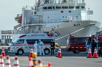 YOKOHAMA, JAPAN - FEBRUARY 06: An ambulance carries a coronavirus victim from the Diamond Princess cruise ship while it is docked at Daikoku Pier where it will be resupplied and newly diagnosed coronavirus cases taken to hospital as it remains in quarantine off the port of Yokohama after a number of the 3,700 people on board were confirmed to have coronavirus, on February 6, 2020 in Yokohama, Japan. 20 passengers are confirmed to be infected with coronavirus as Japanese authorities continue screening people on board. The new cases bring the total number of confirmed infections to 45 in Japan, the largest number outside of China. (Photo by Carl Court/Getty Images)