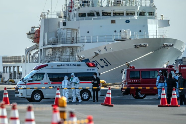 YOKOHAMA, JAPAN - FEBRUARY 06: An ambulance carries a coronavirus victim from the Diamond Princess cruise ship while it is docked at Daikoku Pier where it will be resupplied and newly diagnosed coronavirus cases taken to hospital as it remains in quarantine off the port of Yokohama after a number of the 3,700 people on board were confirmed to have coronavirus, on February 6, 2020 in Yokohama, Japan. 20 passengers are confirmed to be infected with coronavirus as Japanese authorities continue screening people on board. The new cases bring the total number of confirmed infections to 45 in Japan, the largest number outside of China. (Photo by Carl Court/Getty Images)