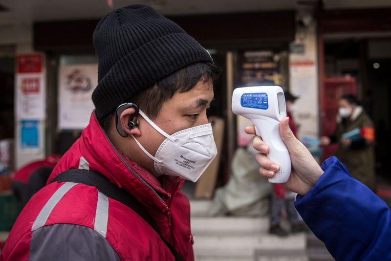 BEIJING, CHINA - JANUARY 30: A sign instructs shoppers to wear protective masks at a mall on January 30, 2020 in Beijing, China. The number of cases of a deadly new coronavirus rose to over 7000 in mainland China Thursday as the country continued to lock down the city of Wuhan in an effort to contain the spread of the pneumonia-like disease which medicals experts have confirmed can be passed from human to human. In an unprecedented move, Chinese authorities put travel restrictions on the city which is the epicentre of the virus and neighbouring municipalities affecting tens of millions of people. The number of those who have died from the virus in China climbed to over 170 on Thursday, mostly in Hubei province, and cases have been reported in other countries including the United States, Canada, Australia, Japan, South Korea, and France. The World Health Organization has warned all governments to be on alert, and its emergency committee is to meet later on Thursday to decide whether to declare a global health emergency. (Photo by Kevin Frayer/Getty Images)