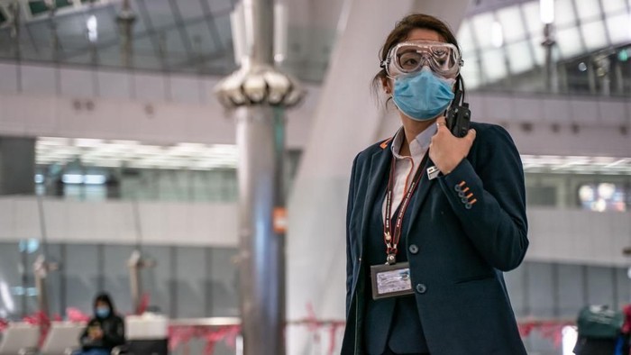 BEIJING, CHINA - JANUARY 30: A sign instructs shoppers to wear protective masks at a mall on January 30, 2020 in Beijing, China. The number of cases of a deadly new coronavirus rose to over 7000 in mainland China Thursday as the country continued to lock down the city of Wuhan in an effort to contain the spread of the pneumonia-like disease which medicals experts have confirmed can be passed from human to human. In an unprecedented move, Chinese authorities put travel restrictions on the city which is the epicentre of the virus and neighbouring municipalities affecting tens of millions of people. The number of those who have died from the virus in China climbed to over 170 on Thursday, mostly in Hubei province, and cases have been reported in other countries including the United States, Canada, Australia, Japan, South Korea, and France. The World Health Organization has warned all governments to be on alert, and its emergency committee is to meet later on Thursday to decide whether to declare a global health emergency. (Photo by Kevin Frayer/Getty Images)