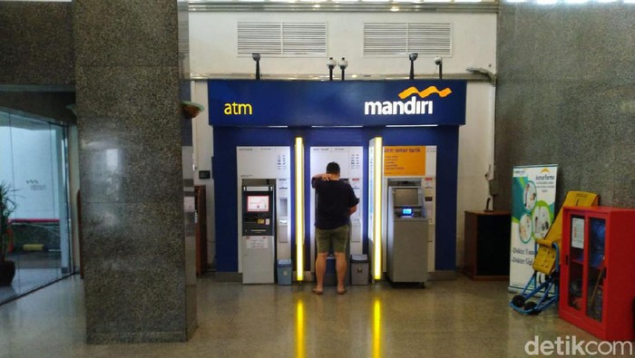 PNS yang sedang mengambil uang di ATM pecahan Rp 20 ribuan (Sachril Agustin Berutu/detikcom)
