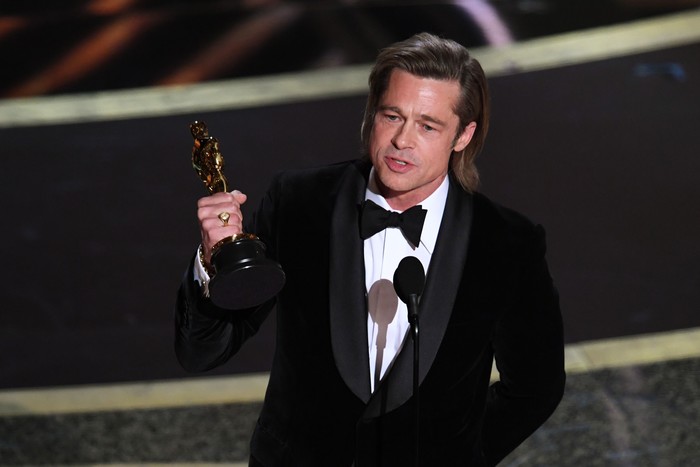 HOLLYWOOD, CALIFORNIA - FEBRUARY 09: (L-R) Regina King presents the Actor in a Supporting Role award for Once Upon a Time...in Hollywood to Brad Pitt onstage during the 92nd Annual Academy Awards at Dolby Theatre on February 09, 2020 in Hollywood, California. (Photo by Kevin Winter/Getty Images)