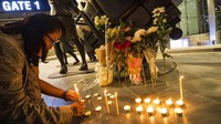Sejumlah karangan bunga dan lilin menghiasi kawasan pusat perbelanjaan Terminal 21 di Korat, Thailand, yang menjadi lokasi penembakan brutal Sabtu (8/2) lalu. AP Photo/Wason Wanichakorn.
