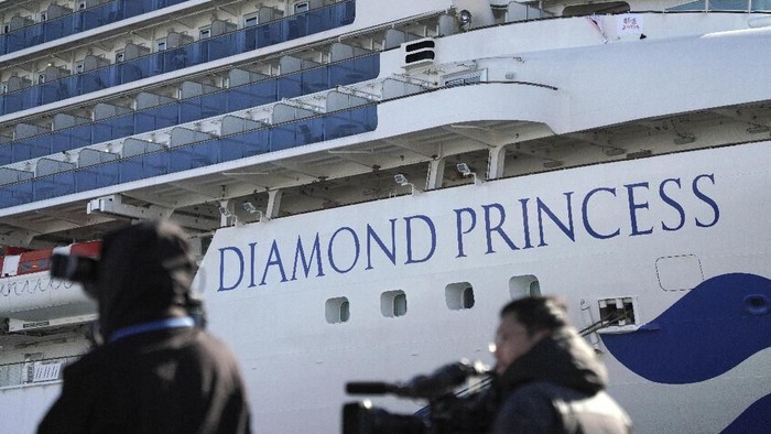 The quarantined cruise ship Diamond Princess is anchored in the Yokohama Port Sunday, Feb. 9, 2020. Japan on Saturday reported three more cases of the coronavirus aboard the Diamond Princess for a total of 64 . There are 3,700 passengers and crew on the Diamond Princess who must remain on board for 14 days. (AP Photo/Eugene Hoshiko)