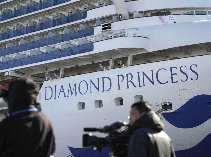 The quarantined cruise ship Diamond Princess is anchored in the Yokohama Port Sunday, Feb. 9, 2020. Japan on Saturday reported three more cases of the coronavirus aboard the Diamond Princess for a total of 64 . There are 3,700 passengers and crew on the Diamond Princess who must remain on board for 14 days. (AP Photo/Eugene Hoshiko)