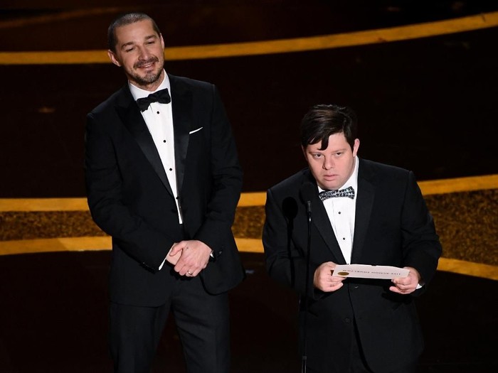 HOLLYWOOD, CALIFORNIA - FEBRUARY 09: (L-R) Shia LaBeouf and Zack Gottsagen speak onstage during the 92nd Annual Academy Awards at Dolby Theatre on February 09, 2020 in Hollywood, California. (Photo by Kevin Winter/Getty Images)