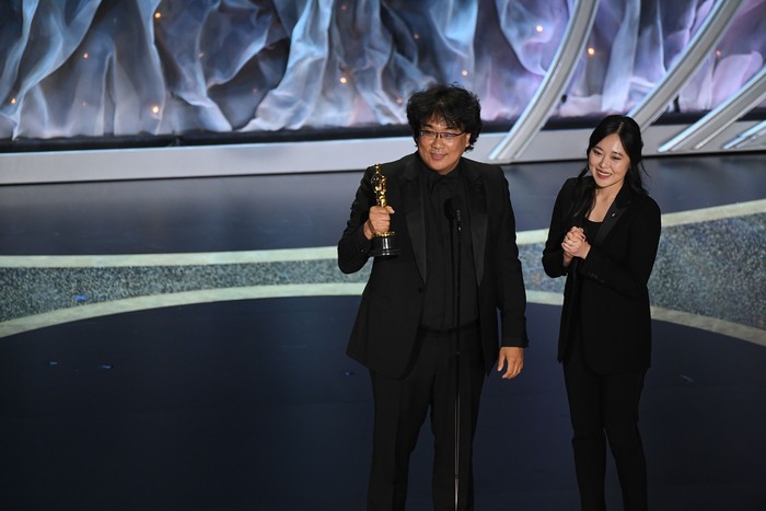 HOLLYWOOD, CALIFORNIA - FEBRUARY 09: (L-R) Bong Joon-ho accepts the International Feature Film award for Parasite with interpreter Sharon Choi onstage during the 92nd Annual Academy Awards at Dolby Theatre on February 09, 2020 in Hollywood, California. (Photo by Kevin Winter/Getty Images)