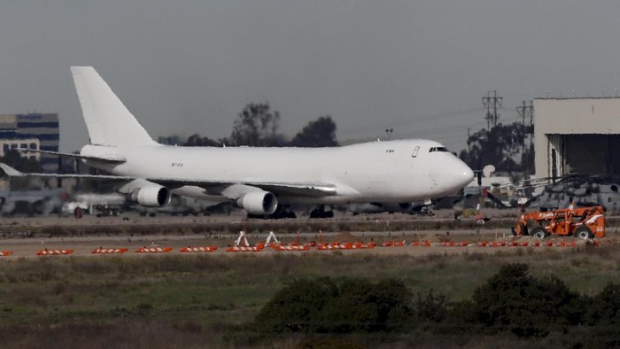 FILE - In this Feb. 5, 2020, file photo, a plane carrying evacuees from the virus zone in China lands at Marine Corps Air Station Miramar in San Diego. An evacuee from China has tested positive for the coronavirus and has been isolated at a San Diego hospital, a person with direct knowledge of the matter tells The Associated Press, Monday, Feb. 10, 2020. (AP Photo/Gregory Bull, File)