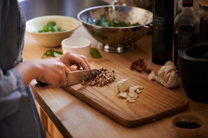 1162183680 Cleaning wood cutting board in kitchen sink