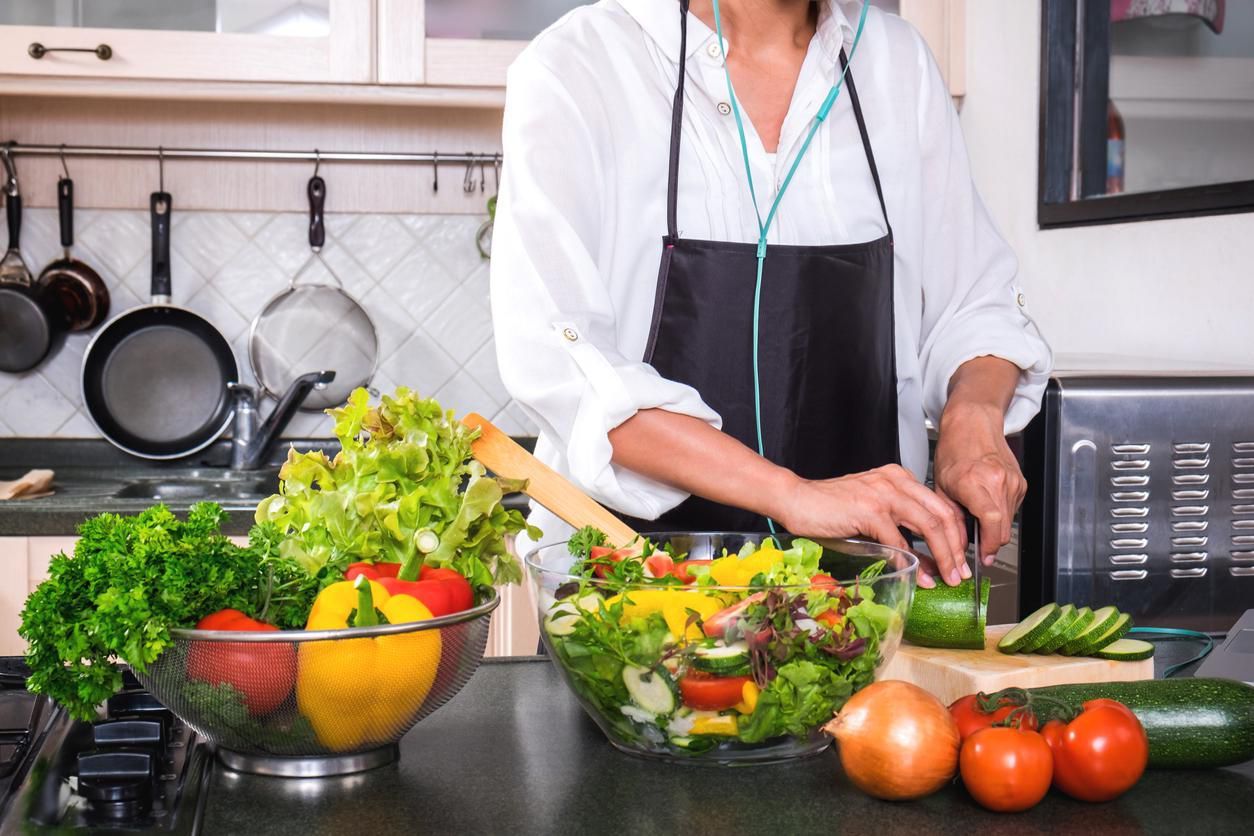 Young happiness Woman Cooking vegetables salad in the kitchen, Healthy food concept.