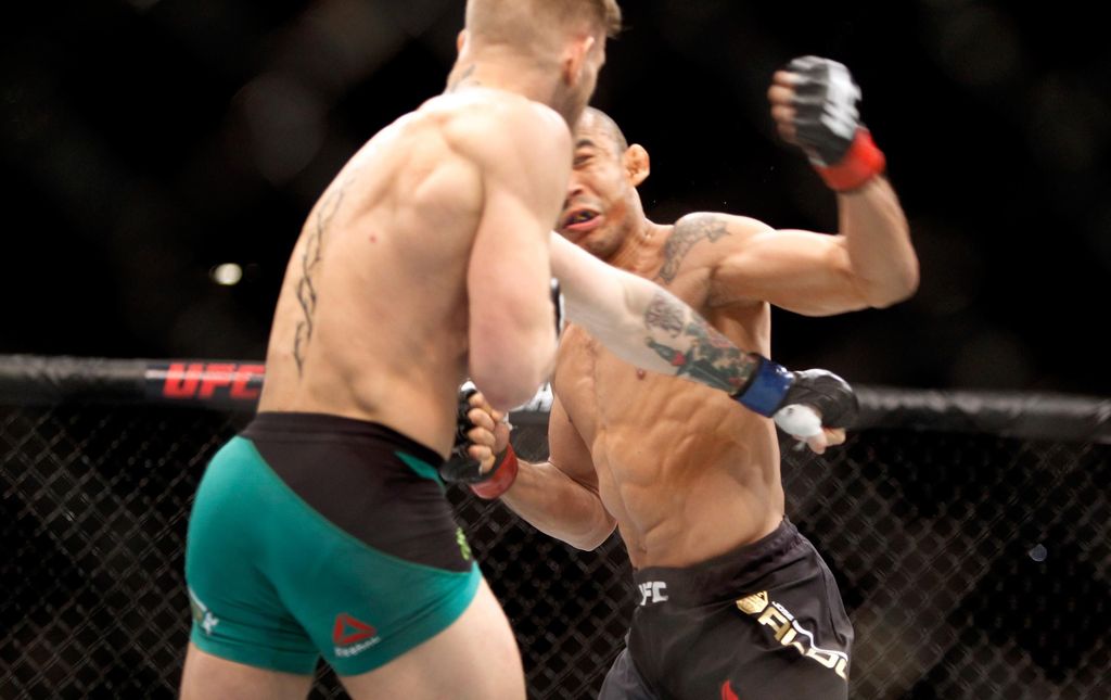 LAS VEGAS, NV - DECEMBER 12:  Conor McGregor (L) knocks out Jose Aldo in the first round of their featherweight title fight during UFC 194 on December 12, 2015 in Las Vegas, Nevada.  (Photo by Steve Marcus/Getty Images)
