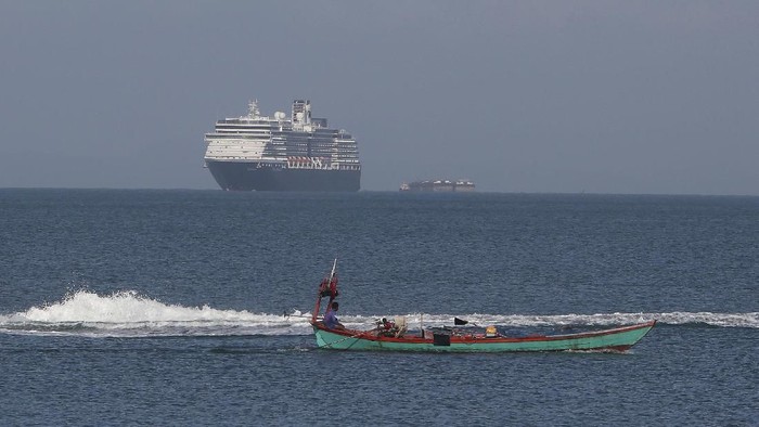 The MS Westerdam, owned by Holland America Line, sails off a port of Sihanoukville, Cambodia, Thursday, Feb. 13, 2020. Holland America Line said the ship has been turned away by the Philippines, Taiwan, Japan and Thailand, though its operator said no cases of the disease have been confirmed among the more than 2,200 passengers and crew. (AP Photo/Heng Sinith)