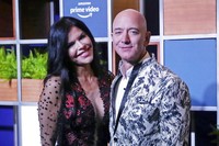 FILE - In this Jan. 16, 2020, file photo, Amazon CEO Jeff Bezos, right and his girlfriend Lauren Sanchez poses for photographs during a blue carpet event organized by Amazon Prime Video in Mumbai, India. Michael Sanchez, the brother of Jeff Bezoss girlfriend, is suing the Amazon founder for defamation, alleging that Bezos and his team falsely told reporters that he provided nude photos of Bezos to the The National Enquirer.  (AP Photo/Rafiq Maqbool, File)