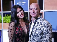 FILE - In this Jan. 16, 2020, file photo, Amazon CEO Jeff Bezos, right and his girlfriend Lauren Sanchez poses for photographs during a blue carpet event organized by Amazon Prime Video in Mumbai, India. Michael Sanchez, the brother of Jeff Bezoss girlfriend, is suing the Amazon founder for defamation, alleging that Bezos and his team falsely told reporters that he provided nude photos of Bezos to the The National Enquirer.  (AP Photo/Rafiq Maqbool, File)