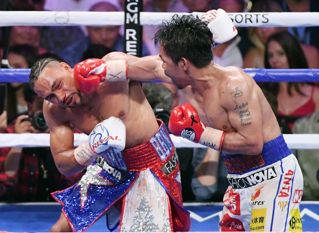 LAS VEGAS, NEVADA - JULY 20:  Manny Pacquiao (R) throws a right at Keith Thurman in the eighth round of their WBA welterweight title fight at MGM Grand Garden Arena on July 20, 2019 in Las Vegas, Nevada. Pacquiao won in a split decision.  (Photo by Ethan Miller/Getty Images)