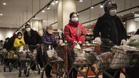 Sejumlah warga mengenakan masker, sarung tangan, dan pakaian pelindung lain seperti jaket saat mengantre untuk membayar makanan di salah satu supermarket yang berada di kawasan Wuhan, Provinsi Hubei, China, Rabu (12/2/2020) waktu setempat. Getty Images/Stringer.