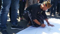 Massa juga melakukan penandatanganan pernyataan sikap dalam spanduk putih.