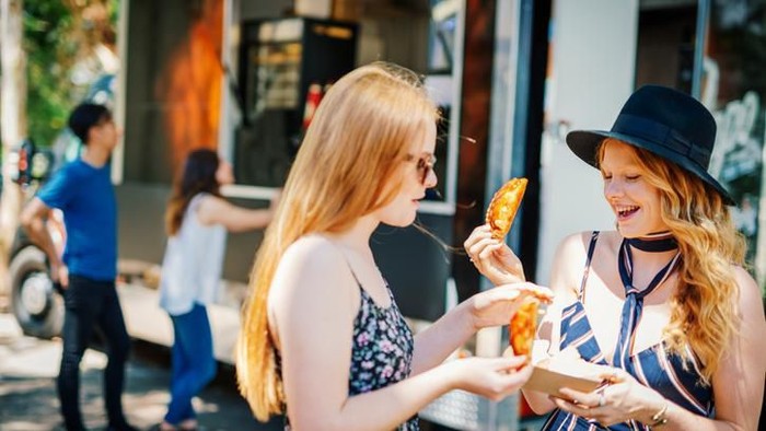 Buenos Aires, Argentina - November 25, 2018: Food trucks and people at a street food market festival on a sunny day